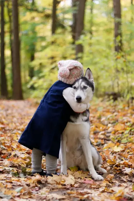 Enfant qui fais un câlin a un chien